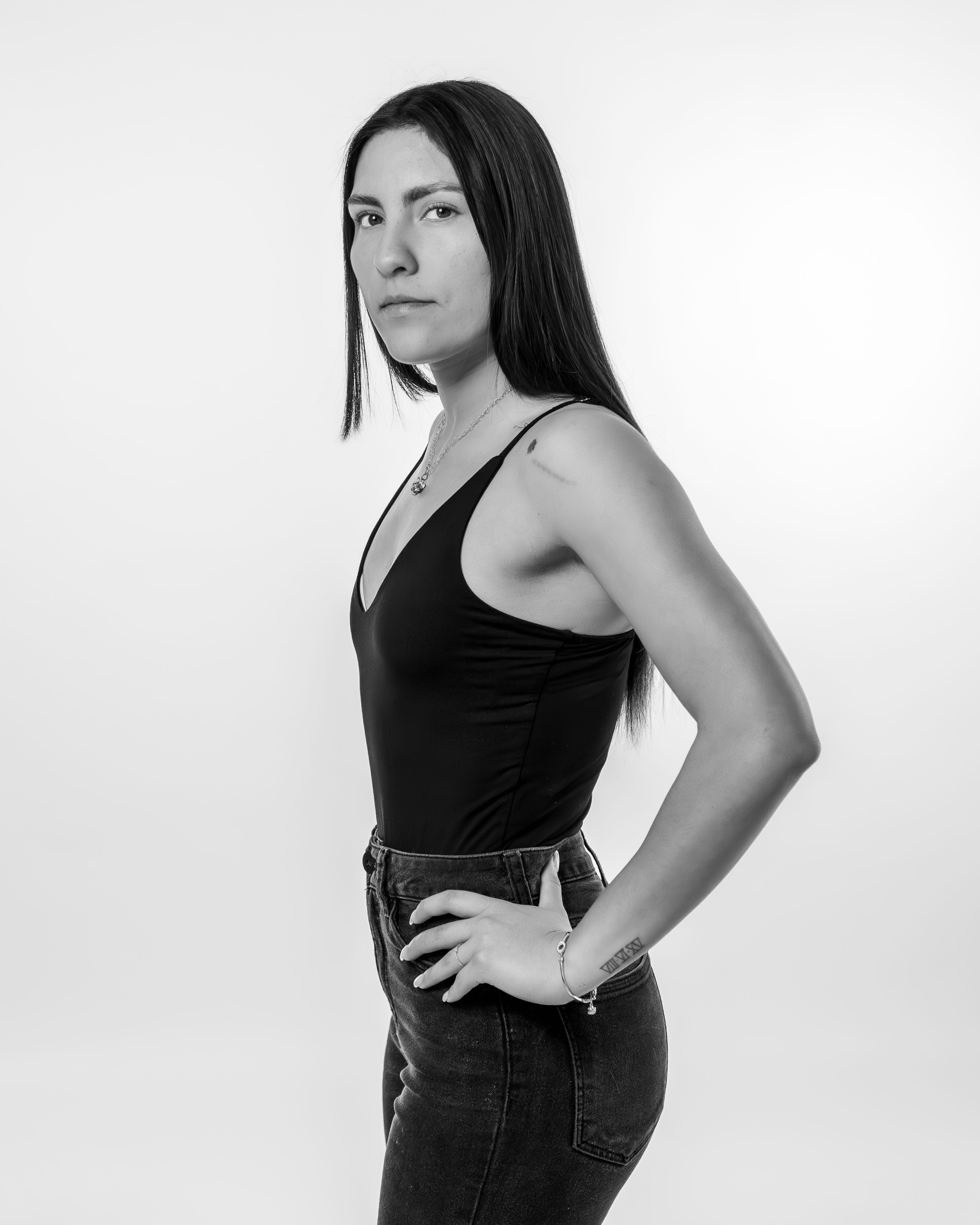 Stylish black and white portrait of a confident woman posing with elegance and poise.