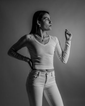 Monochrome portrait of a woman posing confidently in stylish attire.