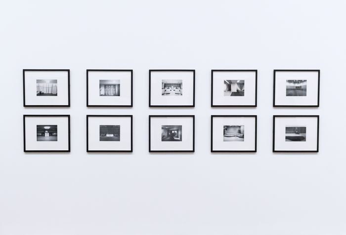 Grid of ten black framed photographs on a white wall, by Dom J on Pexels