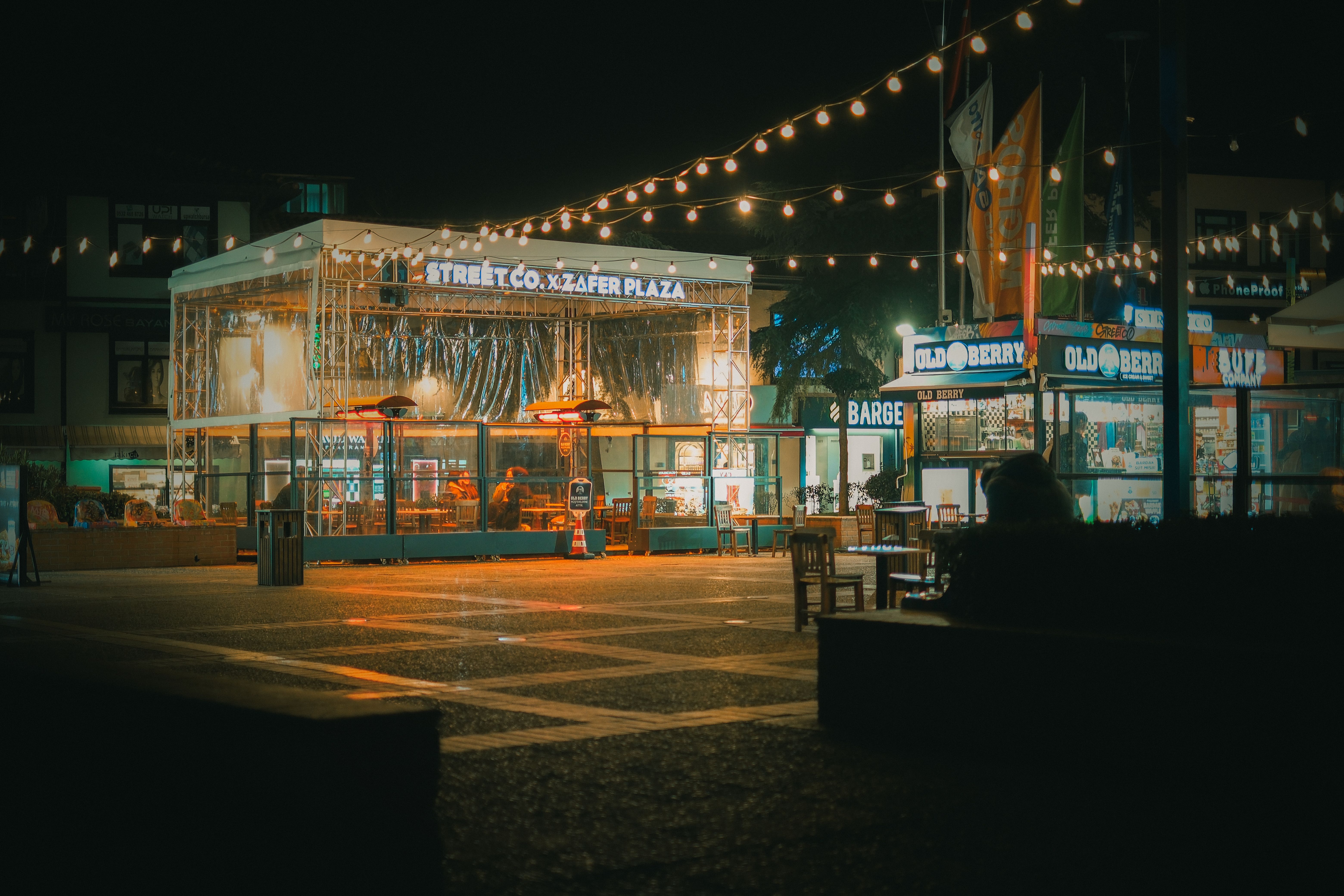 Illuminated hotel and restaurant plaza at night in Aerocity, near Delhi airport