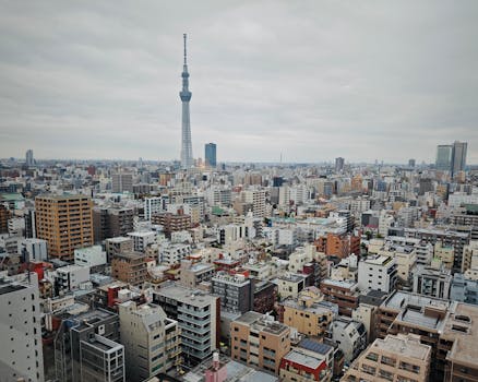 Aerial view of Tokyo cityscape showcasing the famous Tokyo Skytree amid a sea of urban buildings.