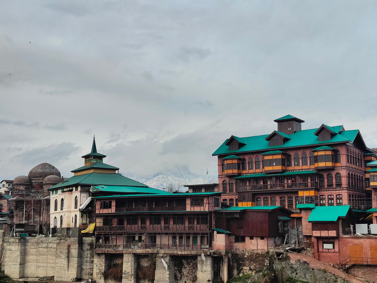 view of traditional architecture against snow capped mountains under a