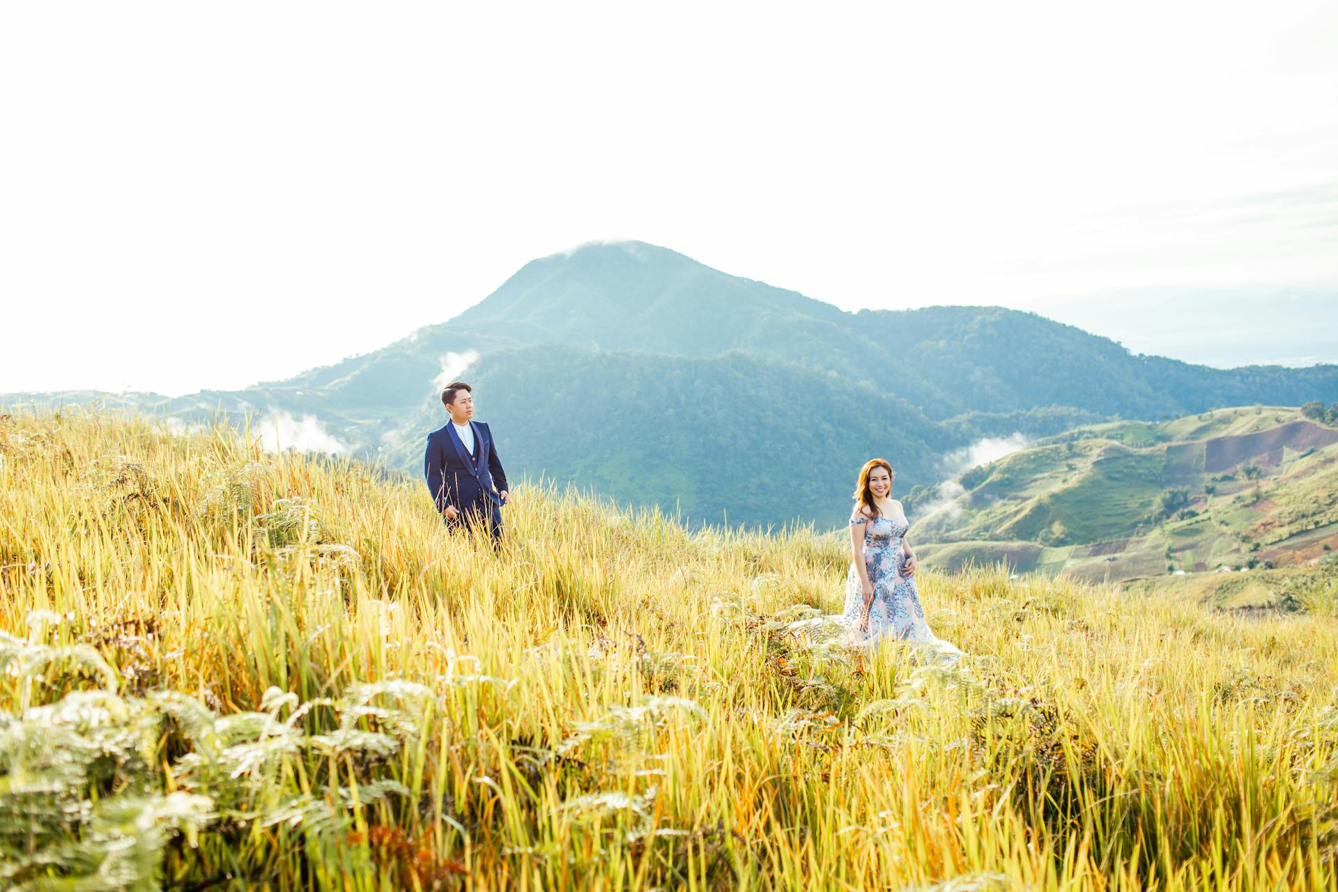 Beautiful outdoor engagement photoshoot in Davao City with a stunning mountain backdrop.