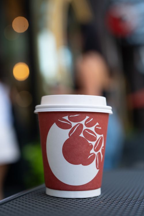 Free A red coffee cup with a unique design in an Arlington, VA coffee shop setting. Stock Photo