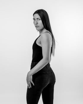 Black and white portrait of a woman in elegant pose showcasing natural beauty and style.