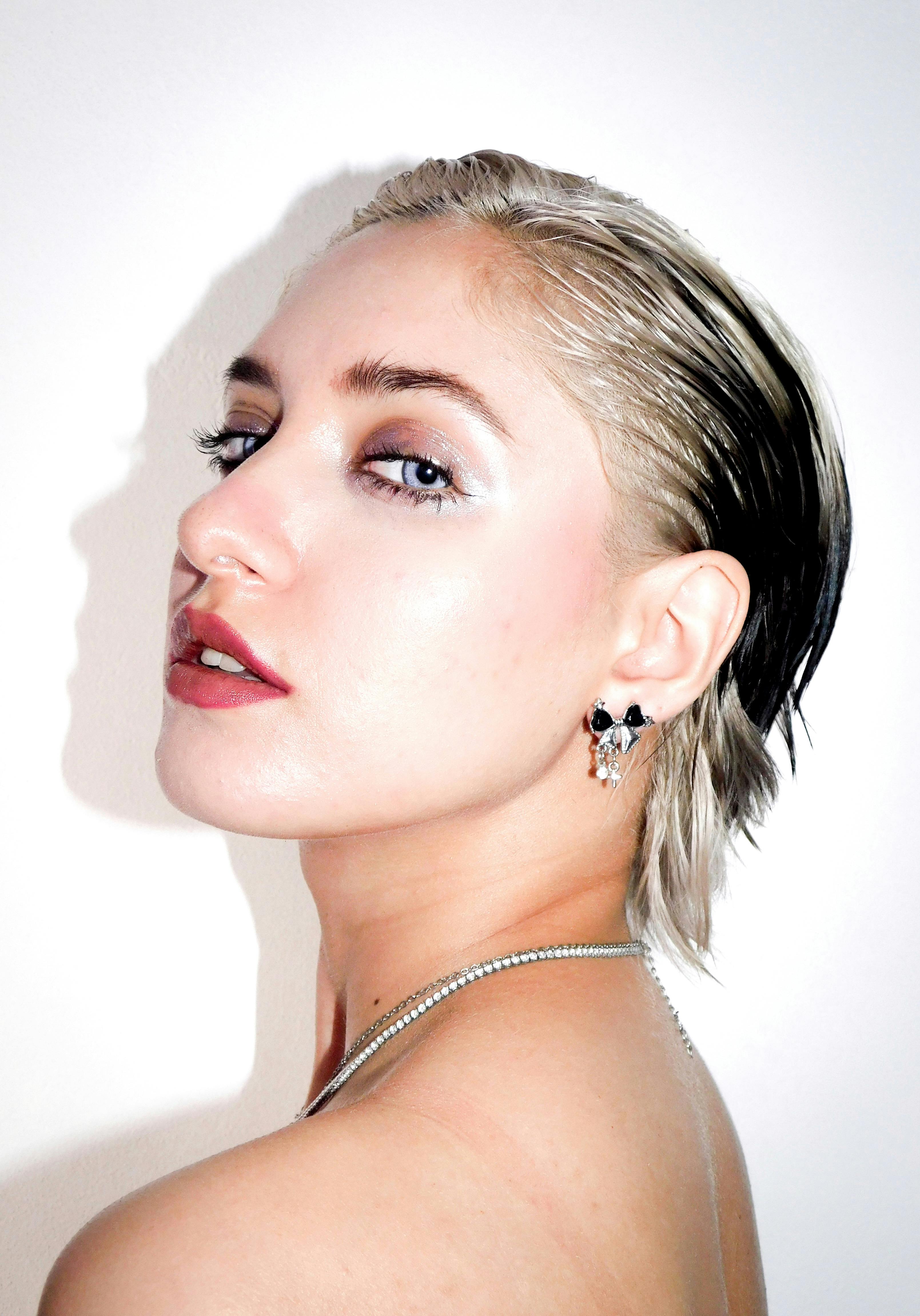 Sophisticated portrait capturing a woman's bold side profile with a sleek wet hairstyle.