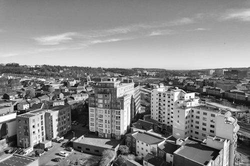 Free Aerial view of a cityscape with residential buildings in a monochromatic tone. Stock Photo