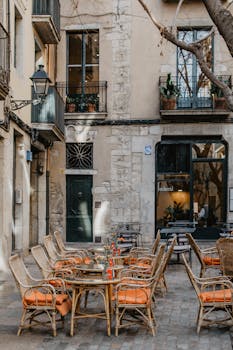 Charming outdoor seating area of a cafe in Barcelona's historic district.