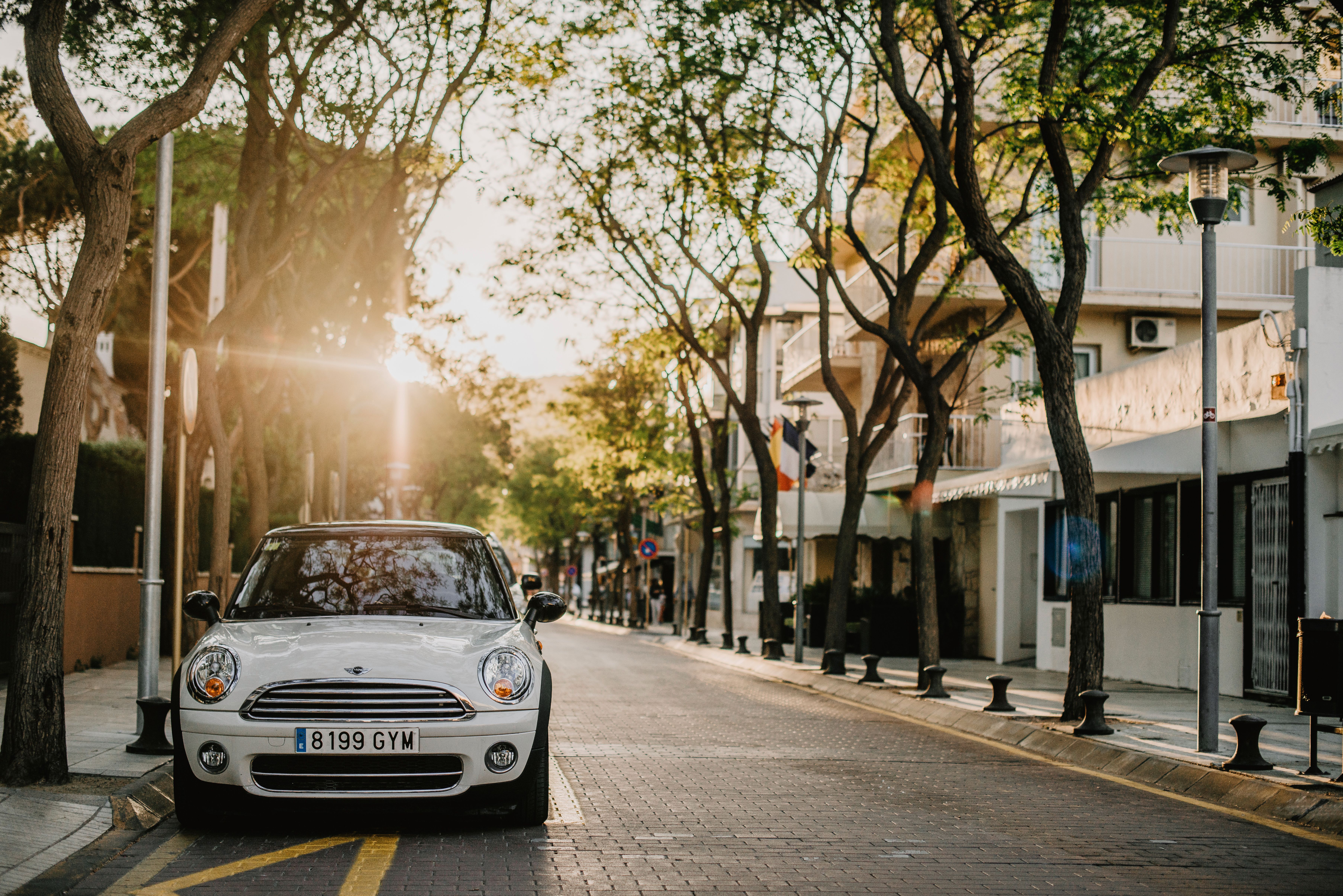 Charming Urban Street with Classic Car at Sunset · Free Stock Photo