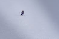 Lone Snowboarder on Pristine Snowy Slope