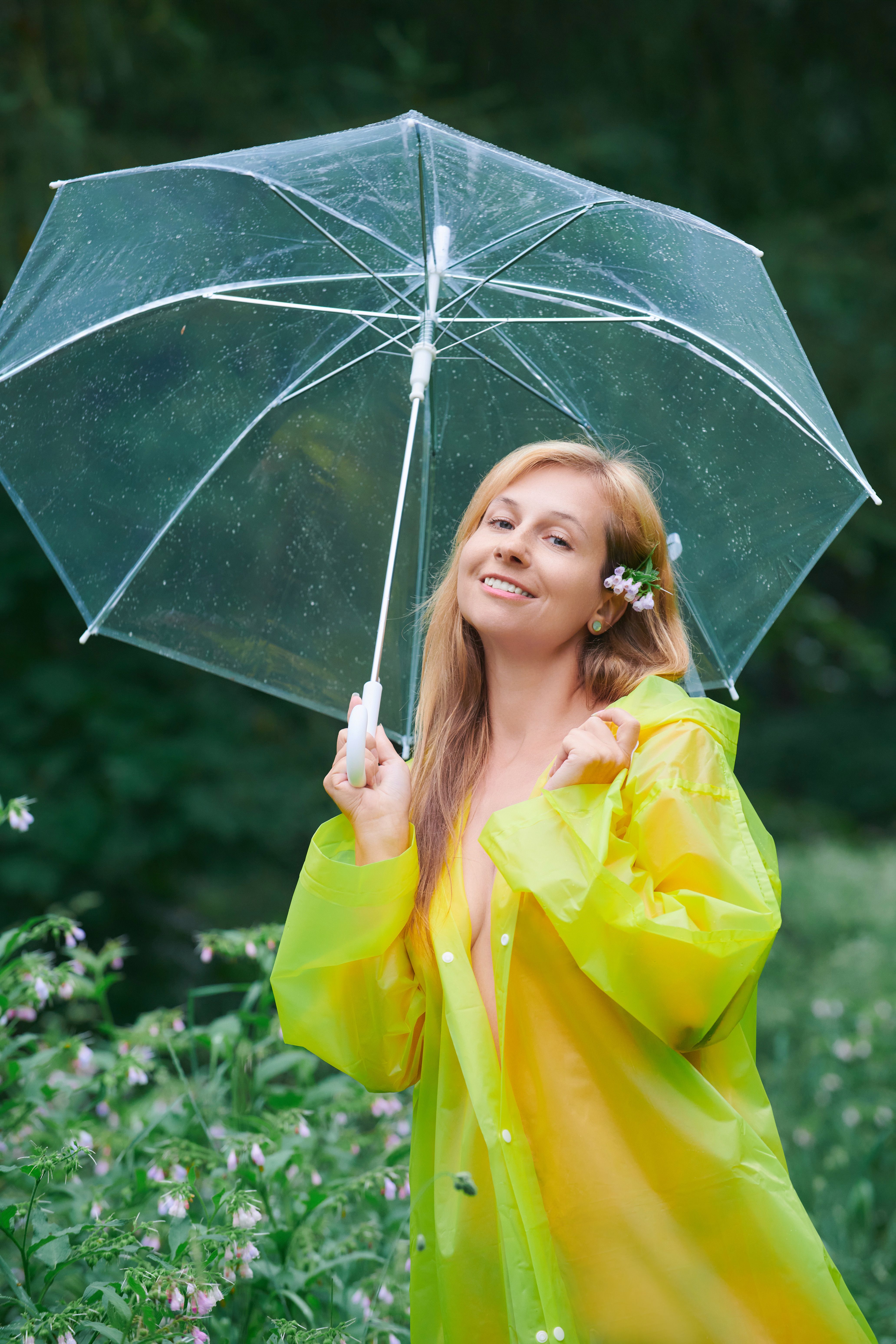 Smiling Woman in Yellow Raincoat Holding Transparent Umbrella · Free ...