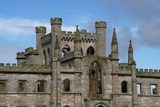 Stunning view of ancient castle ruins with gothic architecture under a clear blue sky., free online jigsaw puzzle on JigsawPuzzlesFreeOnline.org