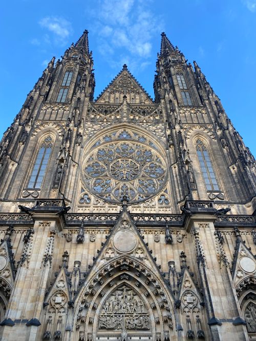 Free A stunning view of St. Vitus Cathedral's intricate gothic facade under a clear blue sky. Stock Photo