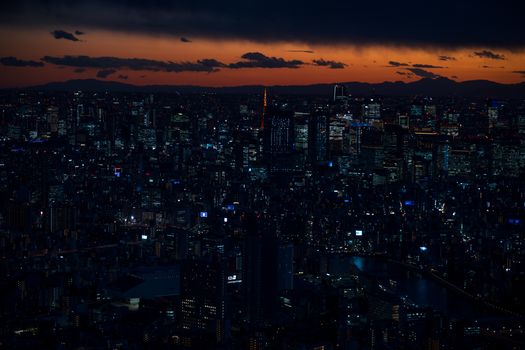 A stunning twilight view of Tokyo's vibrant cityscape featuring iconic landmarks and city lights.
