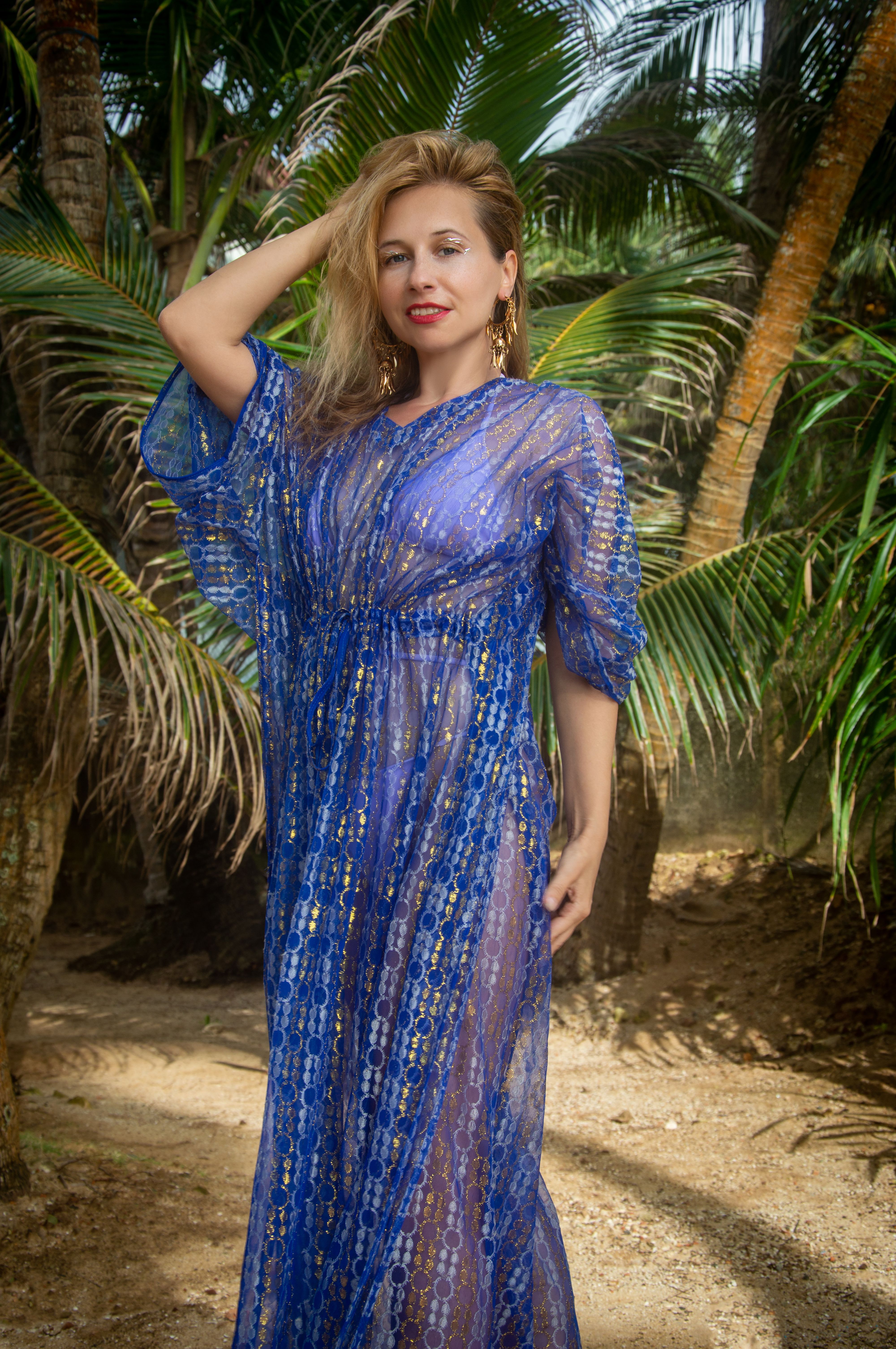 Elegant Woman in Blue Dress Among Palm Trees · Free Stock Photo