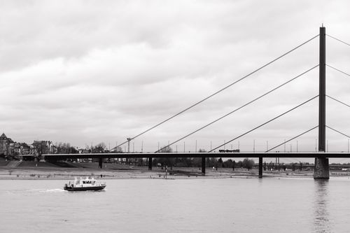 Free Black and white view of the Rhine river and bridge in Düsseldorf, Germany. Stock Photo