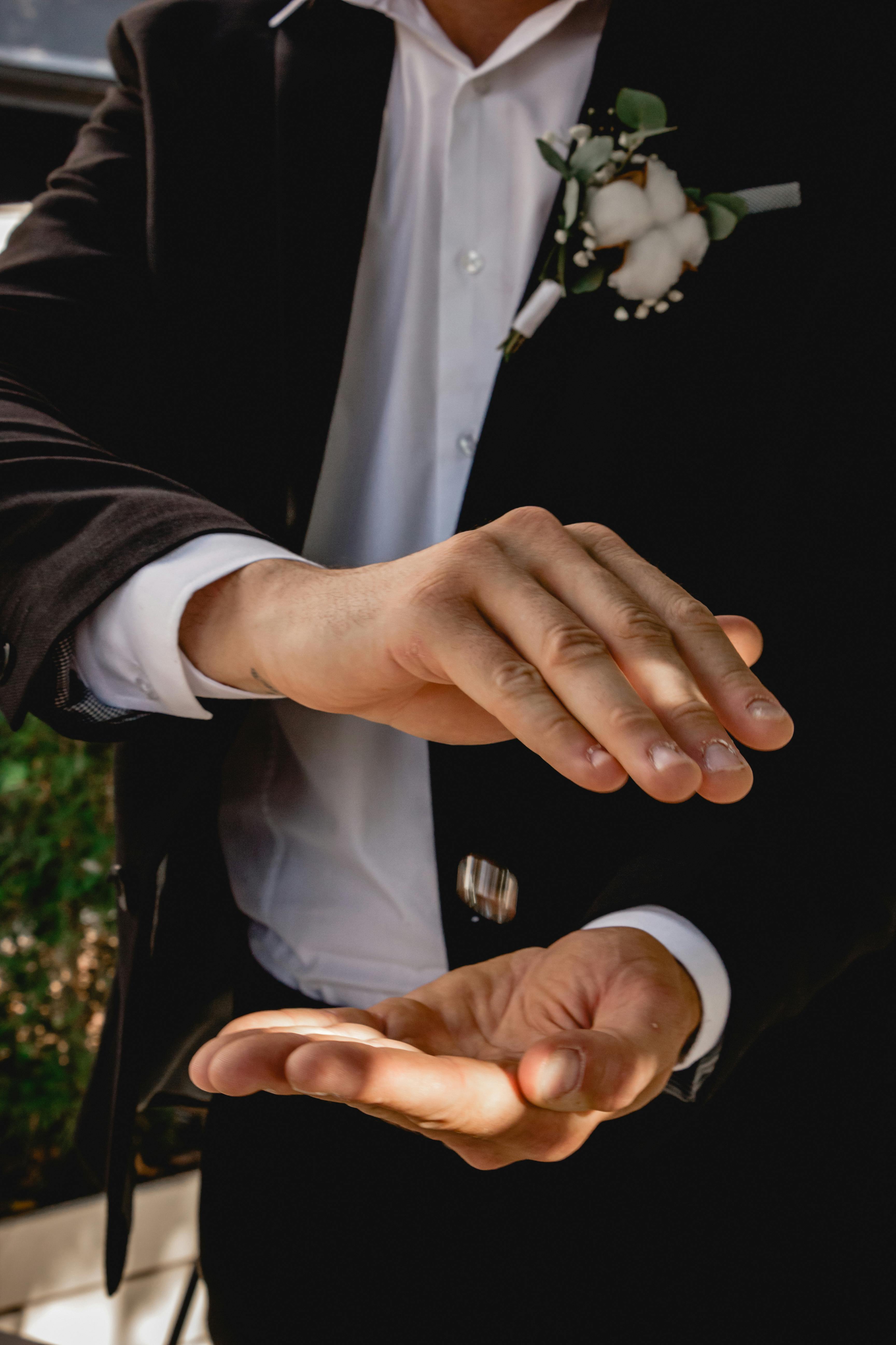 Free A magician deftly performs a coin trick with floating coin and elegant hand movements. Stock Photo