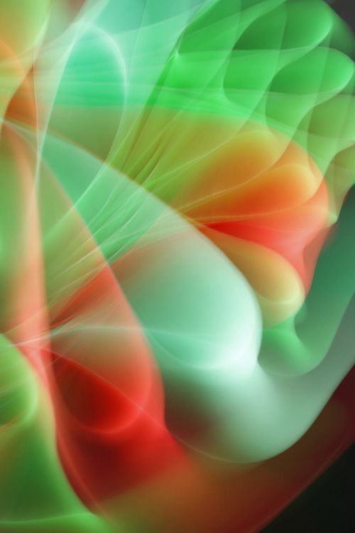 Free Vibrant abstract light waves in red, green, and white, creating a dynamic flow. Stock Photo