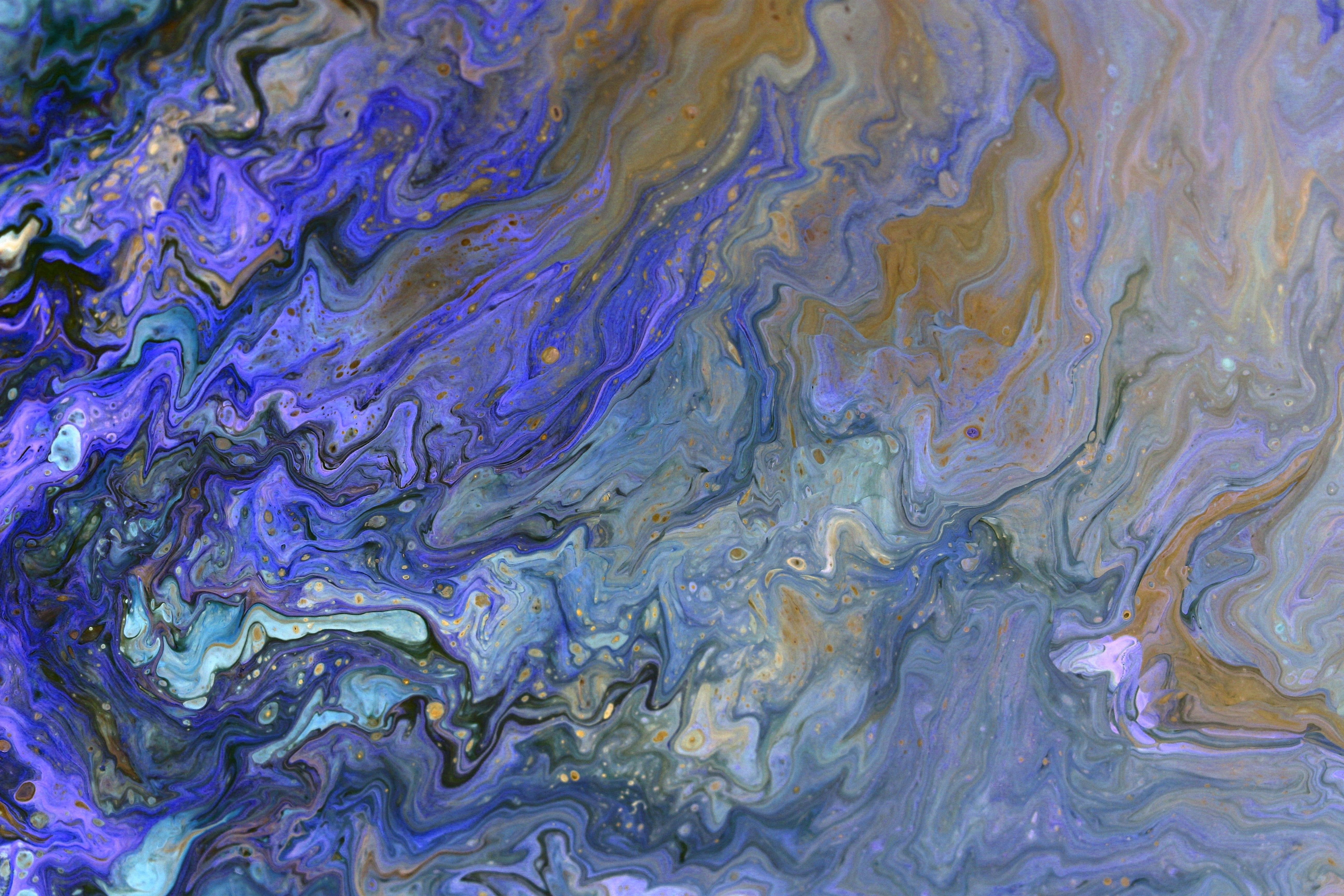 Colorful abstract paint swirl pattern with vibrant hues and fluid style.