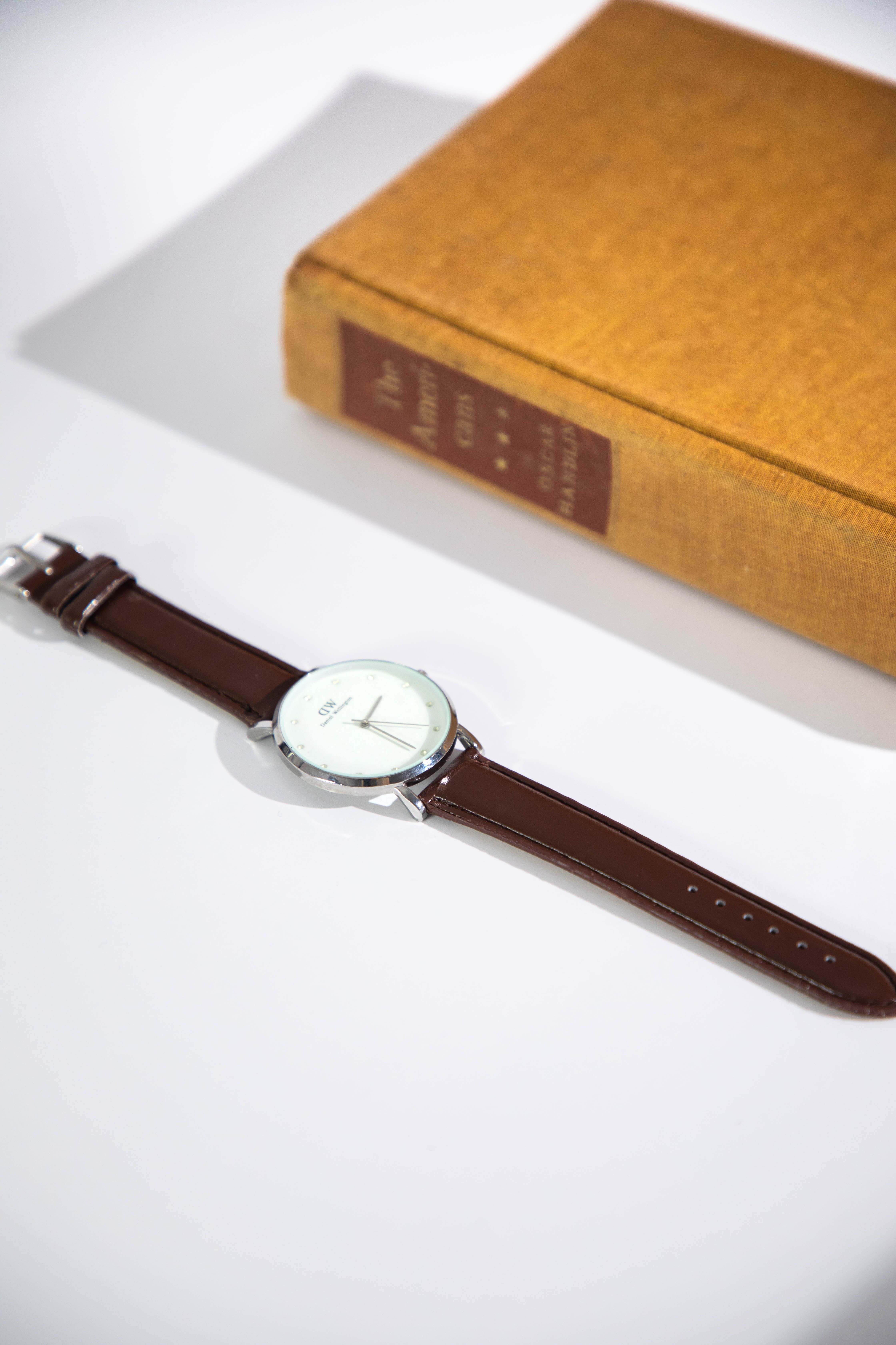 Nox watch beside a vintage book in soft light