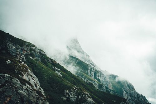 Free Serene mountain landscape with misty clouds shrouding the peak, creating a tranquil atmosphere. Stock Photo