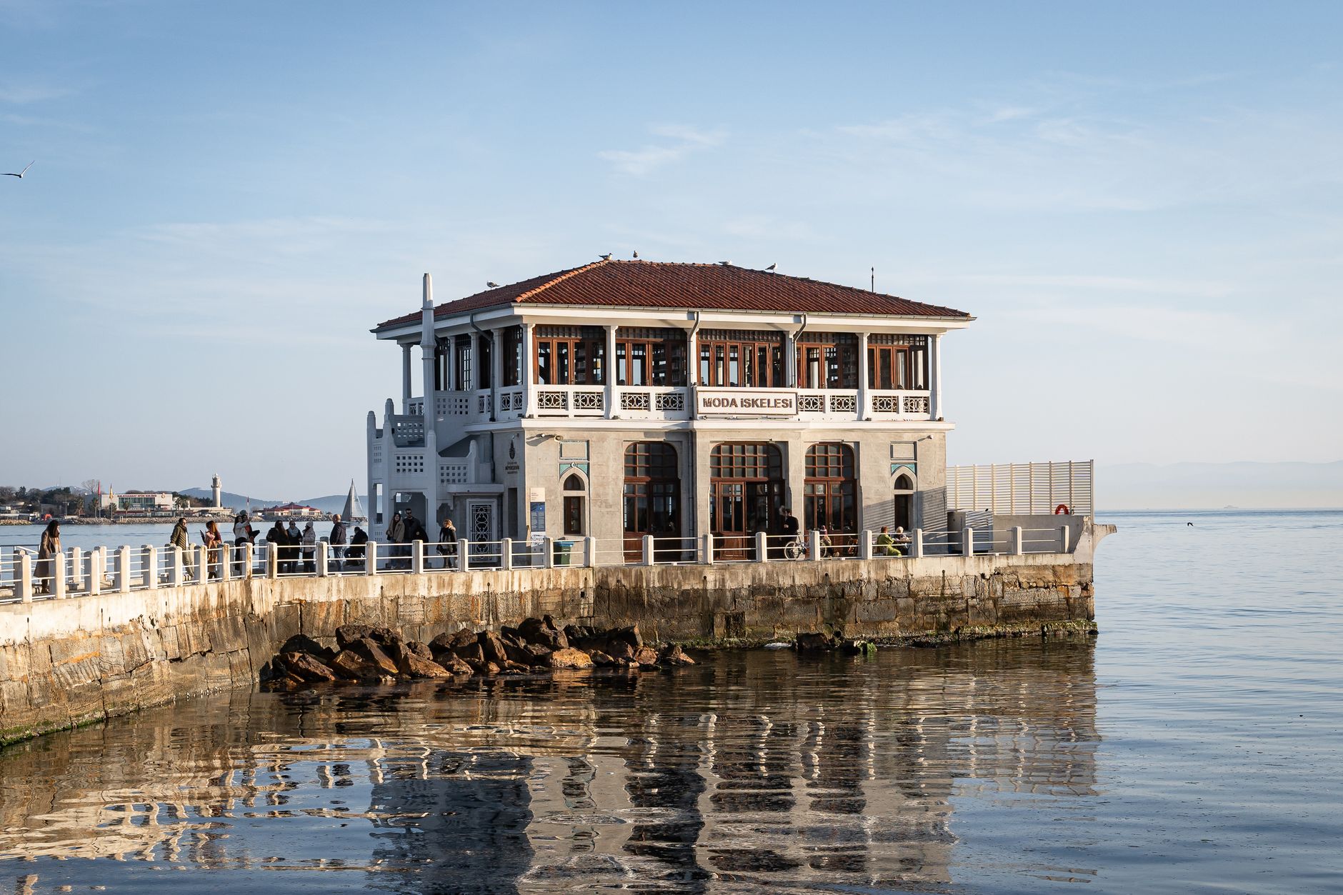 Scenic view of Moda Pier in Istanbul reflecting in the water at sunset.