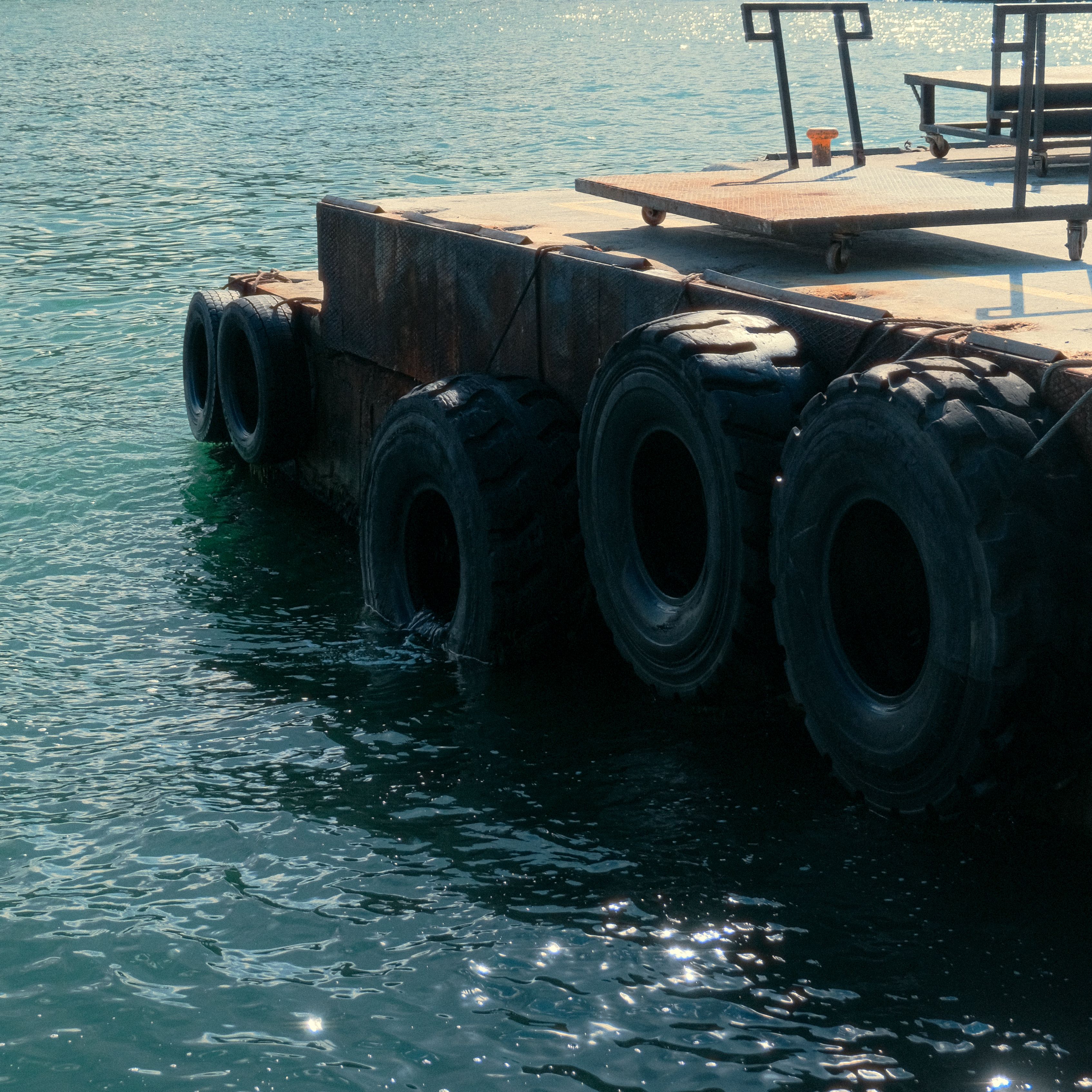 Industrial Floating Platform with Large Tires on Water · Free Stock Photo
