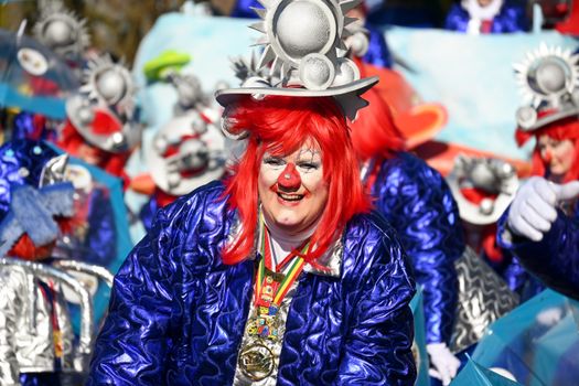 Festive costume featuring a clown with vibrant red hair at the Sittard carnival parade.