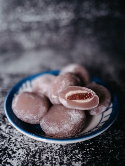 Free Close-up of red bean filled mochi on a blue patterned plate. Stock Photo