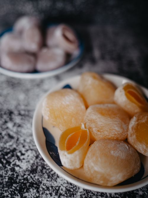 Free Close-up of colorful mochi desserts on ceramic plates, perfect for a sweet treat. Stock Photo