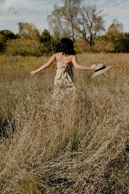잔디 필드에 걷는 여자의 사진