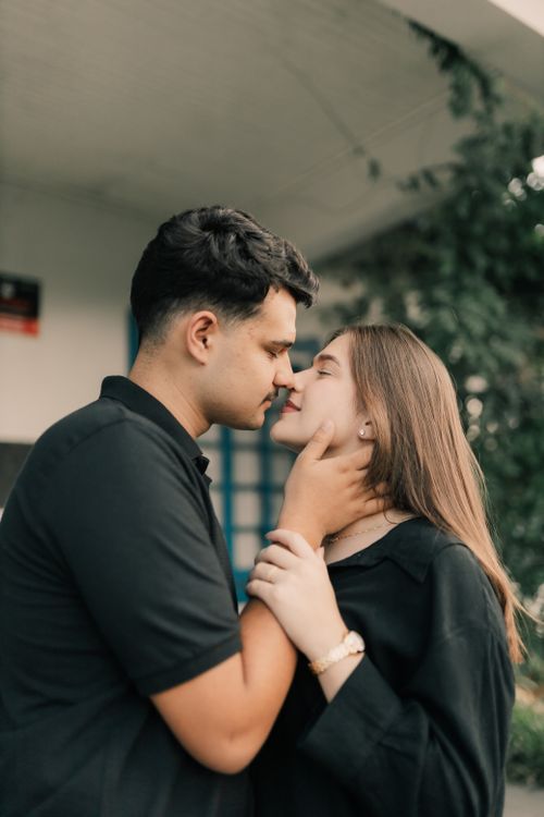 Free Tender moment between a couple in love, showing affection outdoors. Stock Photo