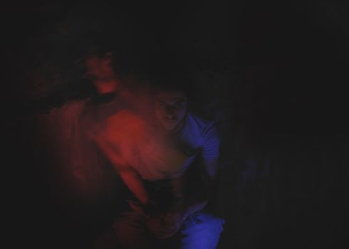 Creative long exposure portrait showing dual images of a man in dim lighting.