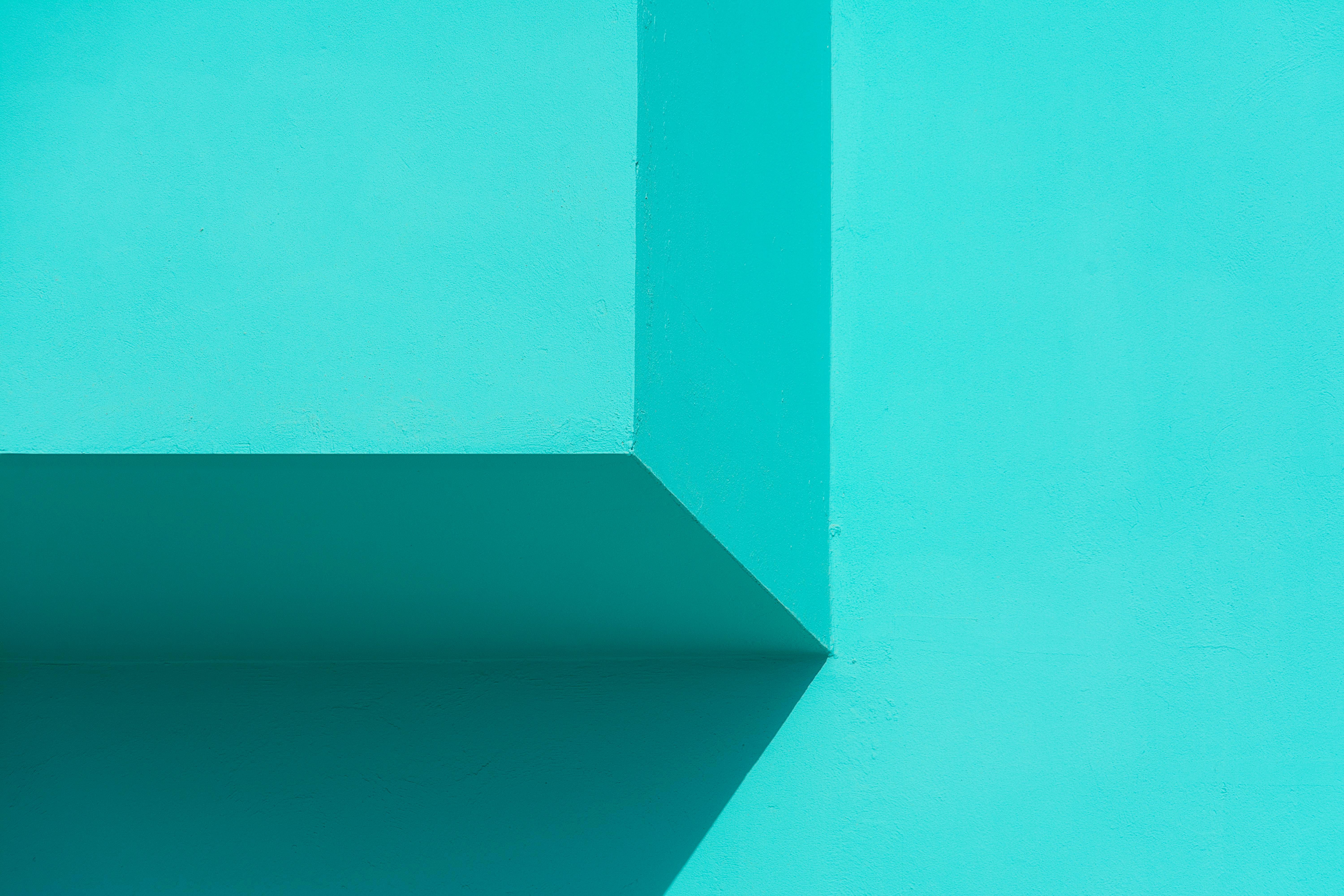Minimalist abstract image featuring geometric shapes in vibrant turquoise hues.