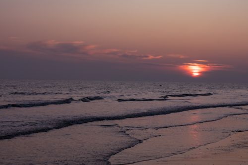 Free Tranquil beach sunset view with vibrant skies over the English shoreline. Stock Photo