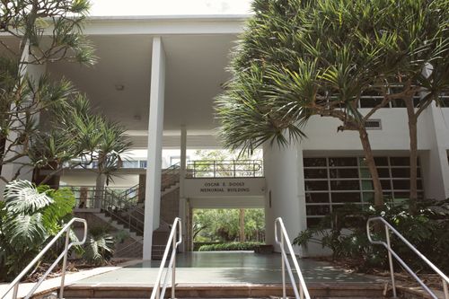 Free An outdoor view of the Oscar E. Dooly Memorial Building at a university campus with surrounding greenery. Stock Photo