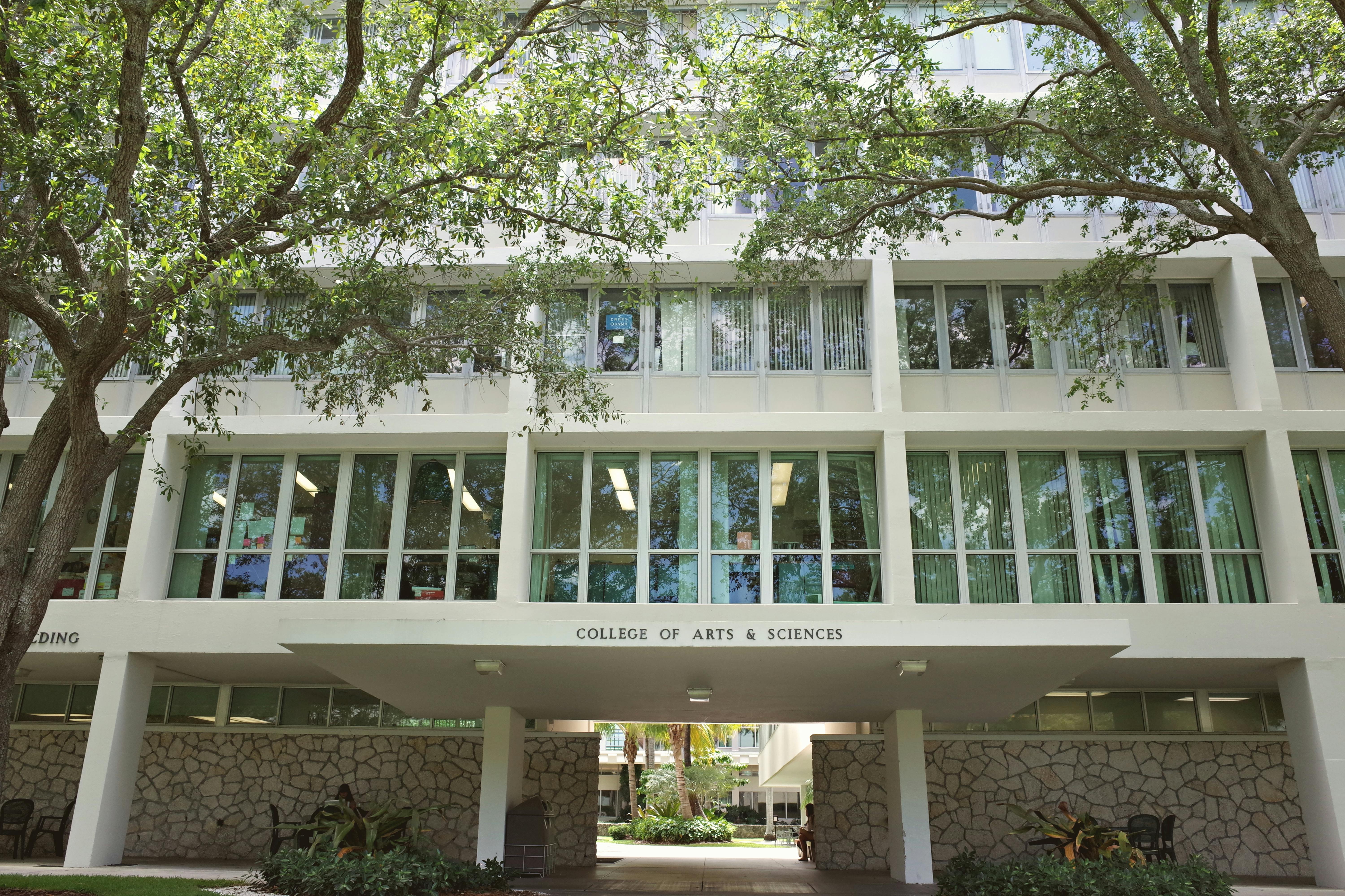 College of Arts & Sciences building at University of Miami, surrounded by lush trees.