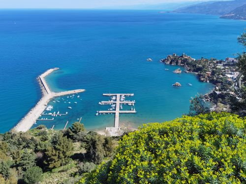 Free Stunning aerial shot of Cefalù's coastline with vibrant blue waters and lush vegetation. Stock Photo