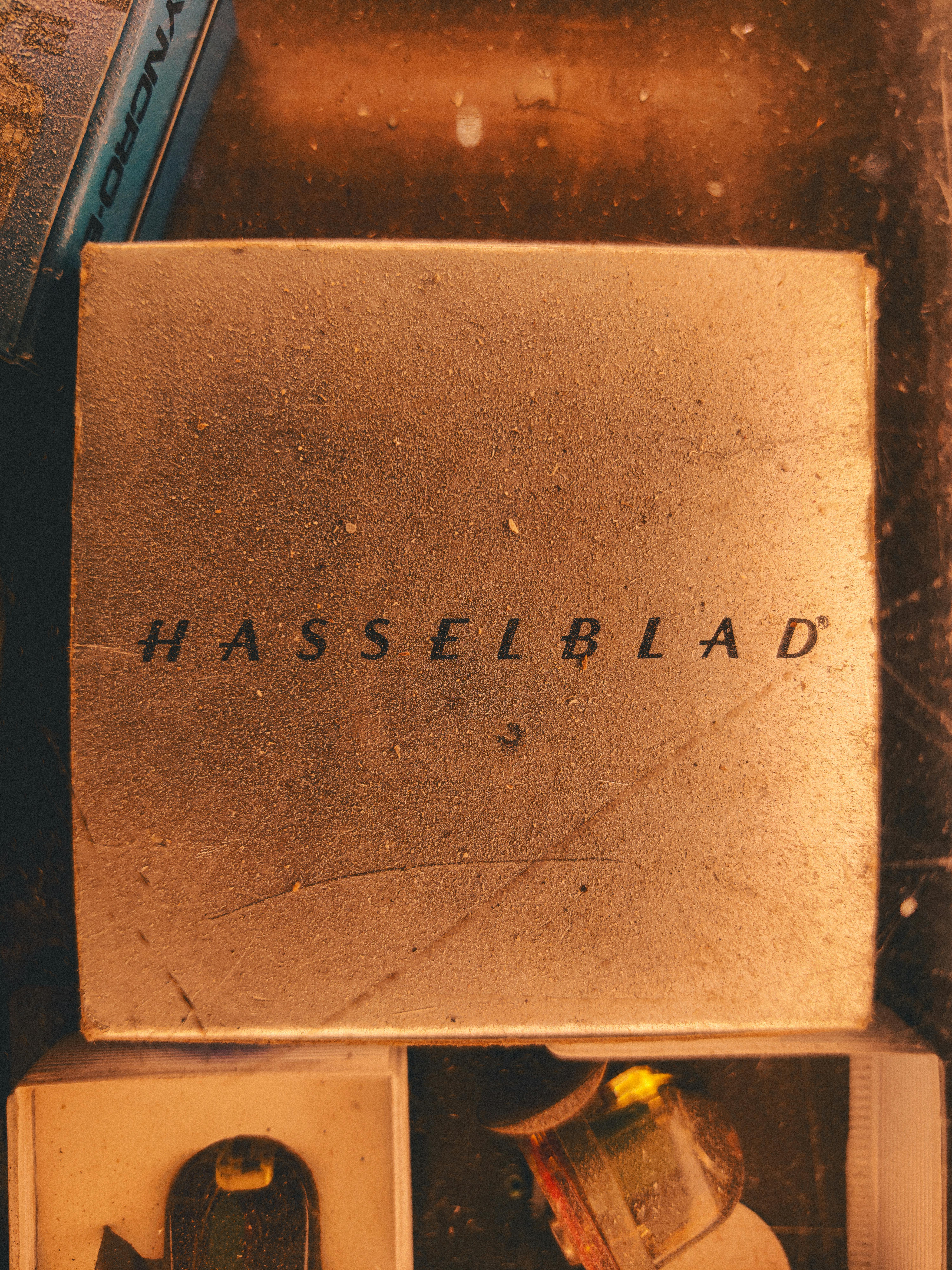 Vintage Hasselblad box on a wooden surface with decorative items around.