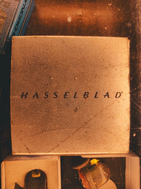 Vintage Hasselblad box on a wooden surface with decorative items around.