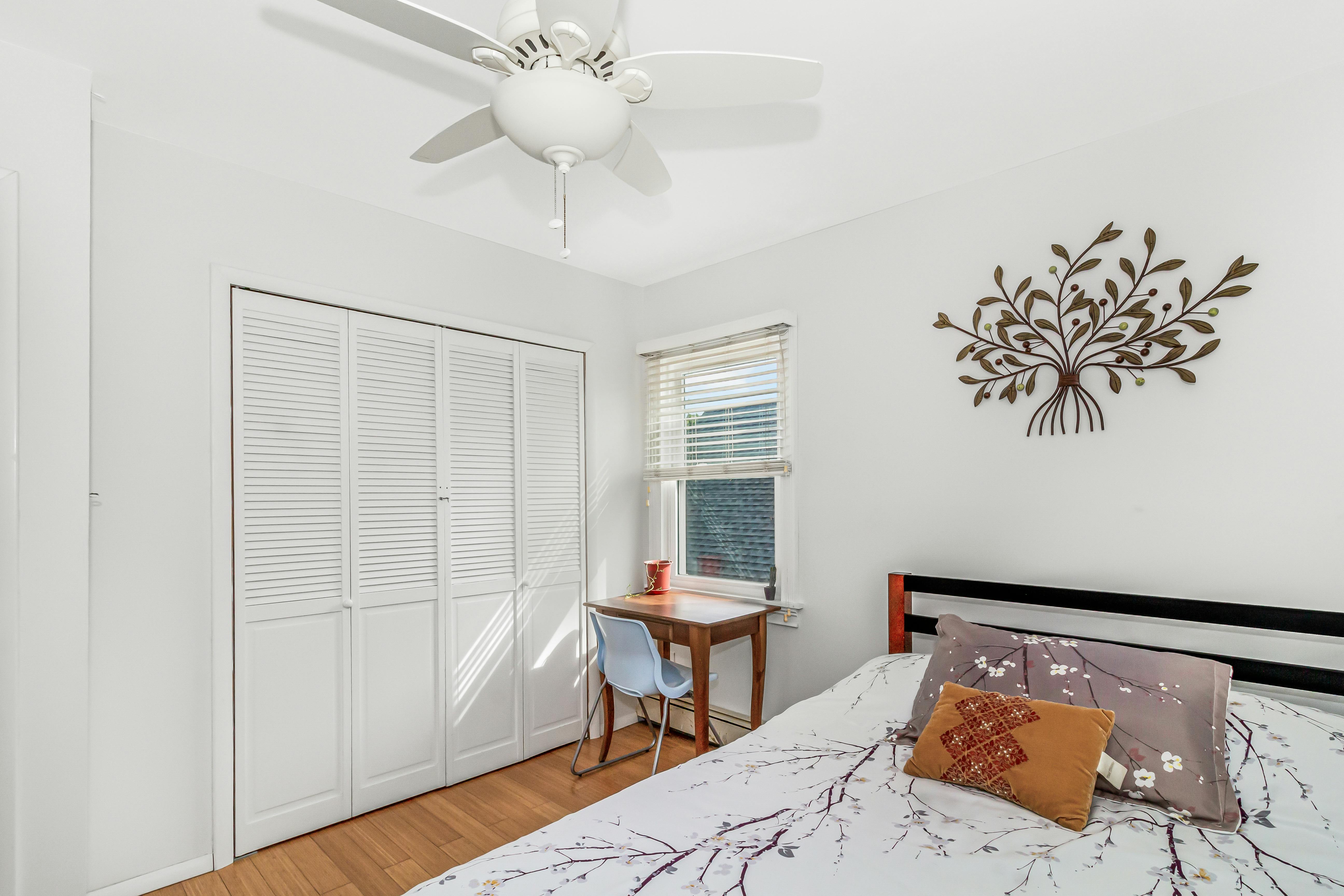 Person sitting in a compact folding chair in a small bedroom