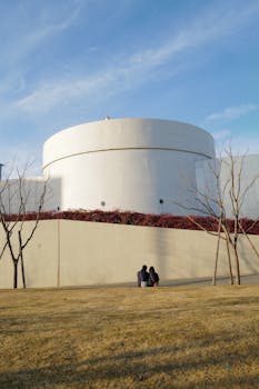 A couple sitting in a Shanghai park, enjoying the serene surroundings and modern architecture.