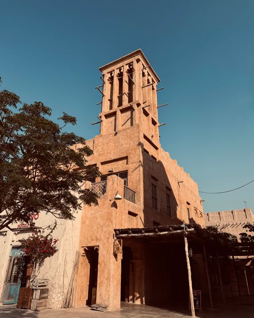 Free An architectural wind tower against a blue sky, showcasing Middle Eastern design. Stock Photo