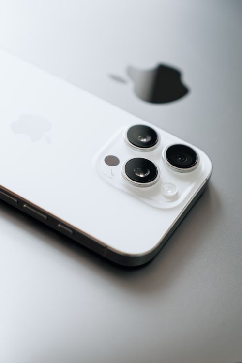 Close-up of a modern iPhone Pro showing the triple-camera module and Apple logo