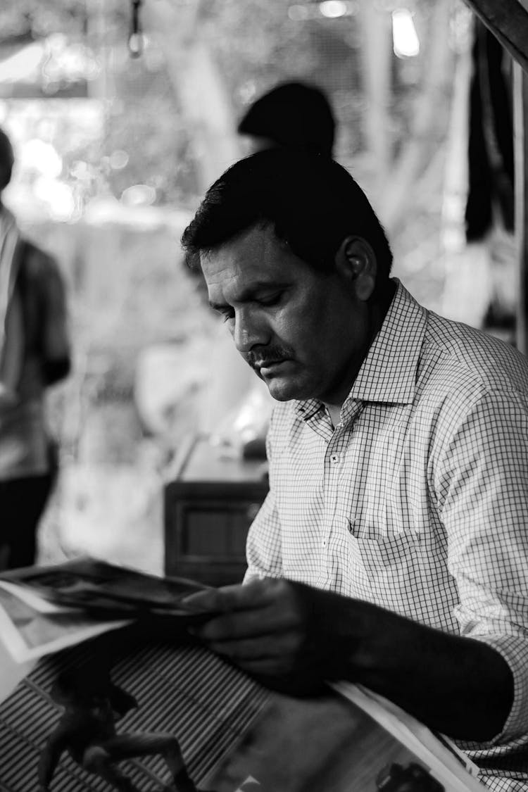 Man Reading Newspaper On Street