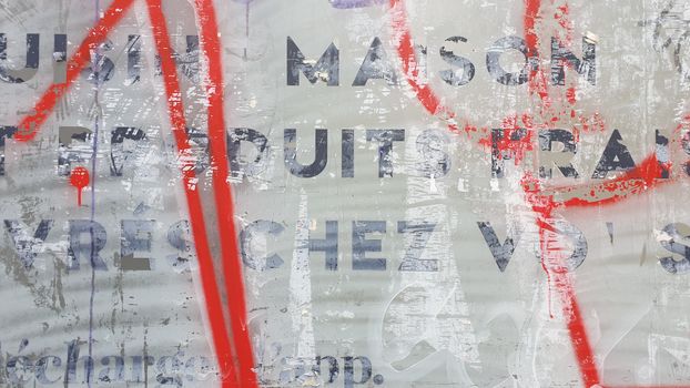 Graffiti art overlaying a textured wall with faded text. Perfect for urban and street art projects.