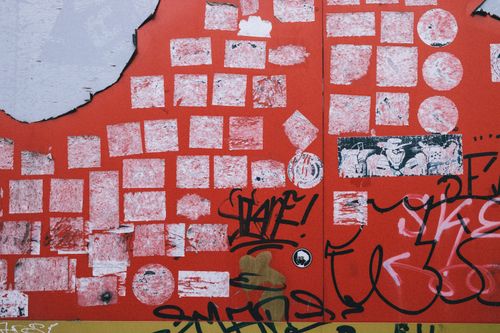 Free Vibrant urban graffiti on a red wall, showcasing artistic street expressions. Stock Photo