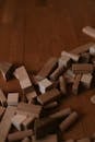 Scattered Wooden Building Blocks on Wooden Floor