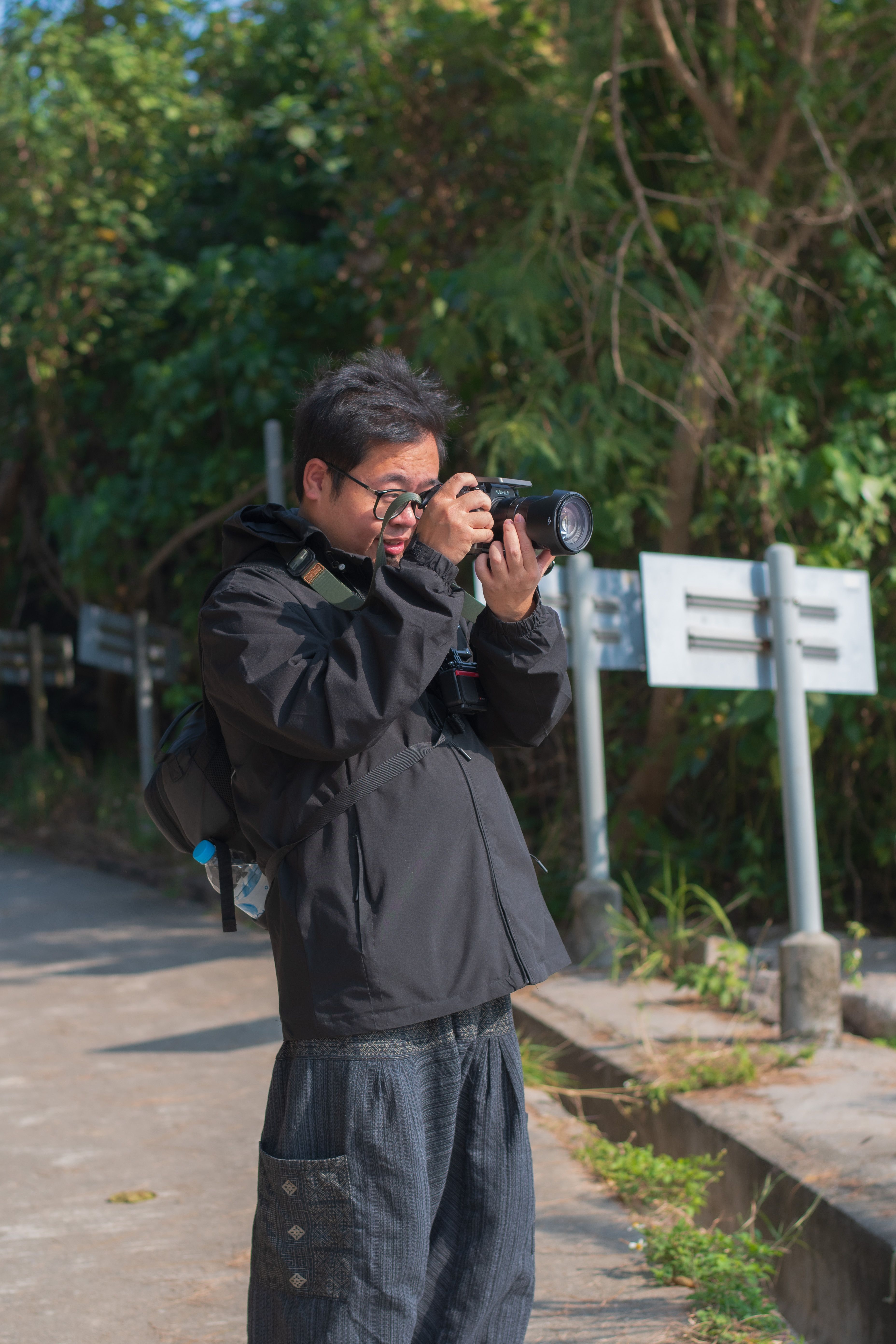 Photographer taking pictures outdoors in New Territories, Hong Kong.