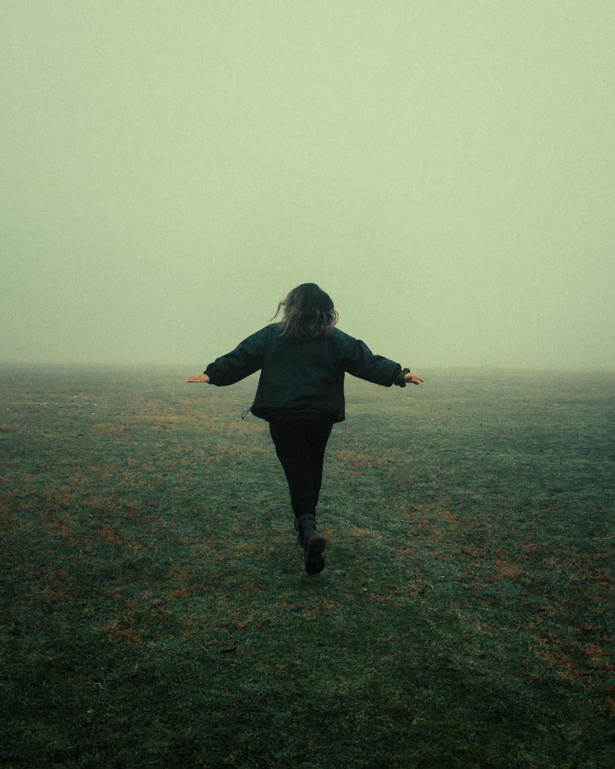 Run Freely Woman Running Freely in Foggy Field · Free Stock Photo
